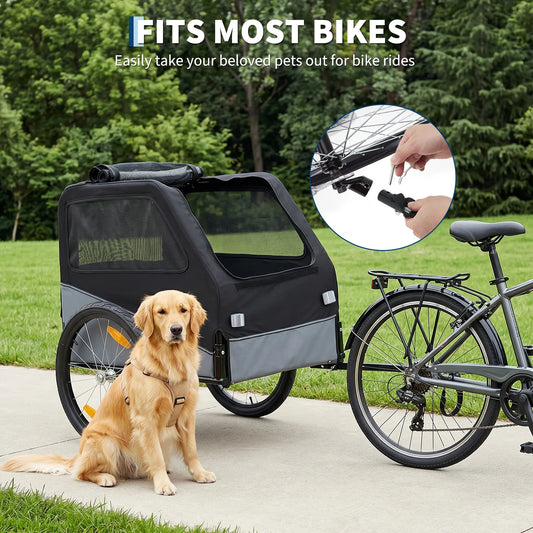 A black and gray bicycle cargo pet trailer is shown attached to a bicycle outdoors on a paved path, with a golden retriever sitting beside it. Text at the top reads 'FITS MOST BIKES' and 'Easily take your beloved pets out for bike rides,' with a circular inset showing a hand attaching a leash clip.