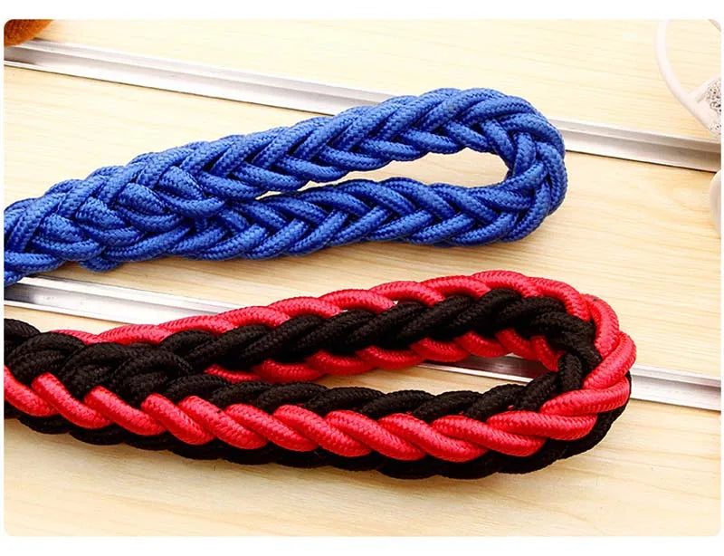 Two braided ropes, one blue and one red and black, on a wooden surface.