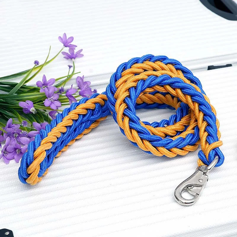 Blue and orange braided leash with a metal clip on a white surface with purple flowers.