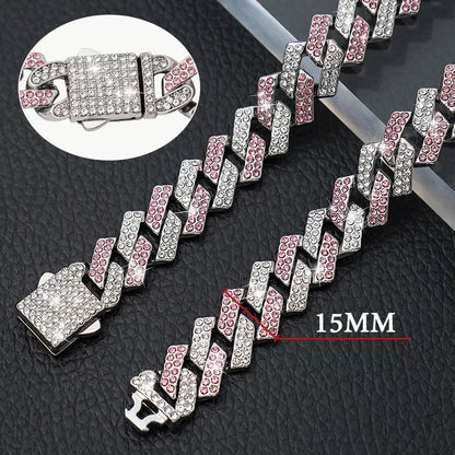 Silver and pink chain with close-up of clasp on a textured black surface