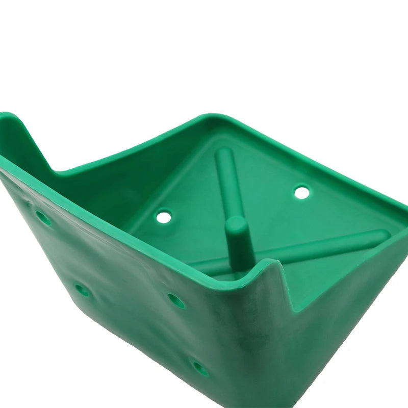 A green plastic container or tray with a triangular shape, featuring a central vertical post and circular holes on the sides, shown against a plain white background.