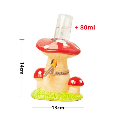 A small mushroom-shaped glass container or perfume bottle with a clear cylindrical glass insert on top, shown with red, white, and green painted detailing. Black measurement lines and red text indicate dimensions: 14cm height, 13cm width, and +80ml capacity, on a plain white background.