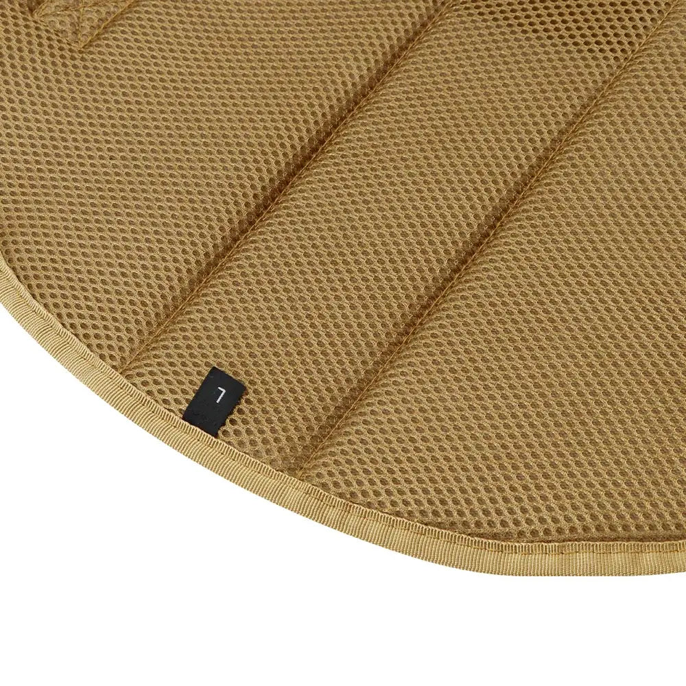Close-up of a brown quilted saddle pad with a brand label.