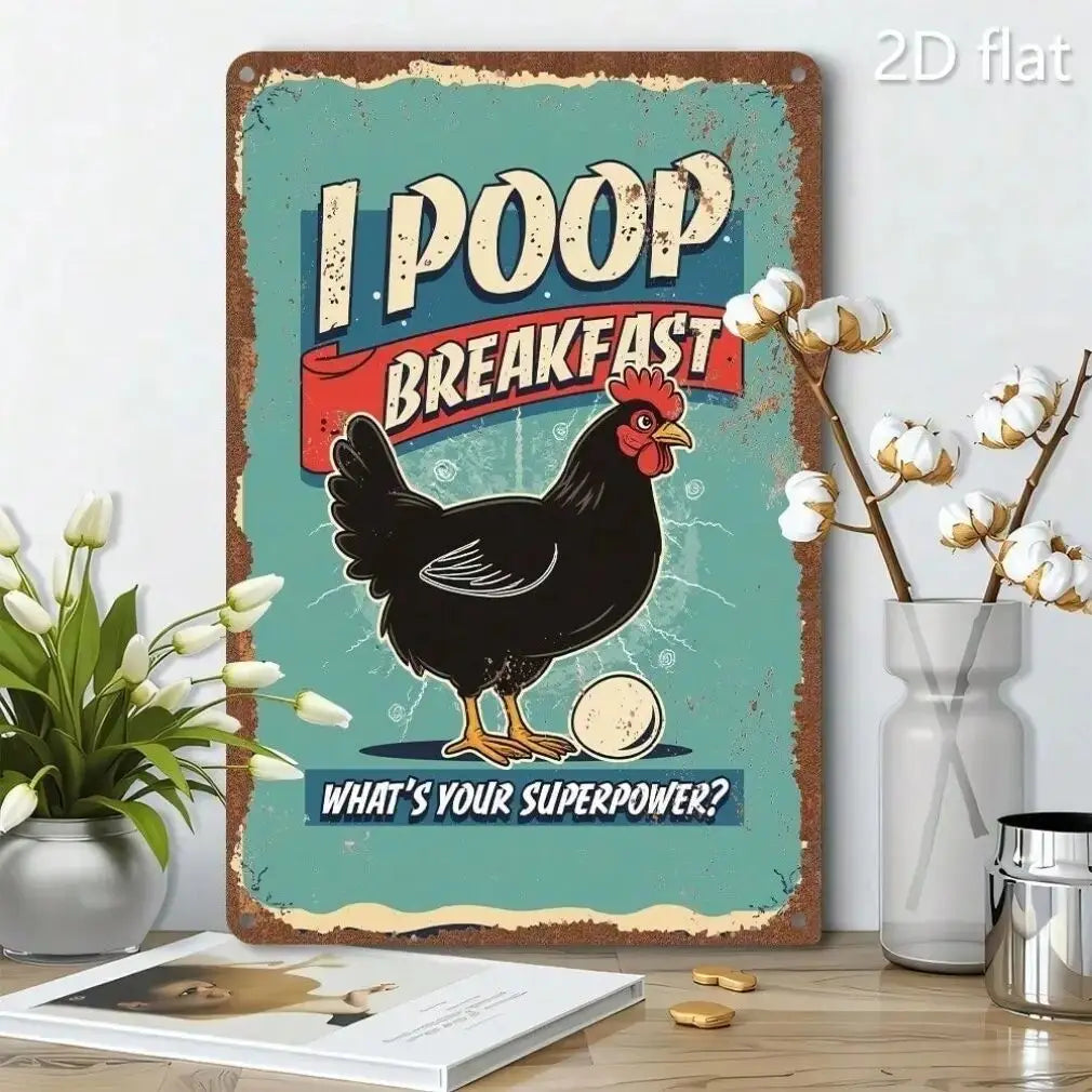 A rectangular decorative tin sign with a humorous chicken graphic and the text 'I POOP BREAKFAST' and 'WHAT'S YOUR SUPERPOWER?' displayed on a tabletop with flowers and a vase in a styled room setting.