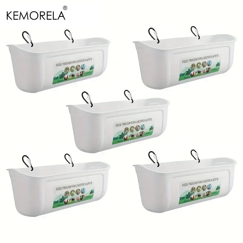 Five white plastic hanging pet bowls with black metal loops and a printed label on the front, arranged on a plain white background. The brand name KEMORELA appears in the top left corner.