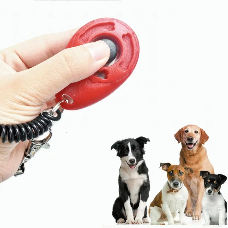 Red pet training clicker held by a hand with four dogs on a white background