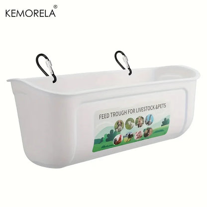 White plastic livestock and pet feed trough with two black hanging clips, featuring a printed label that reads 'FEED TROUGH FOR LIVESTOCK & PETS' with small animal illustrations. KEMORELA logo appears in the top left corner.