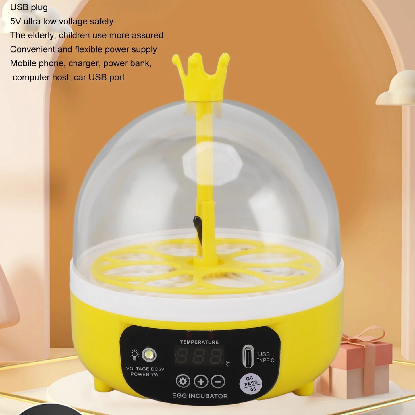 Yellow egg incubator with a clear dome on an orange background