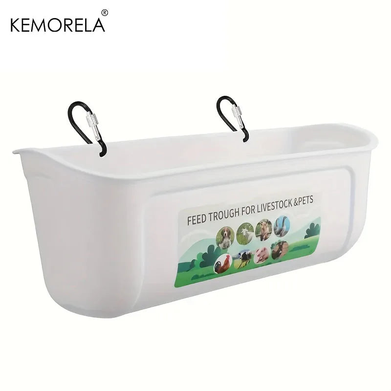 White plastic livestock and pet feed trough with two black hanging clips, featuring a printed label that reads 'FEED TROUGH FOR LIVESTOCK & PETS' with small animal illustrations. KEMORELA logo appears in the top left corner.