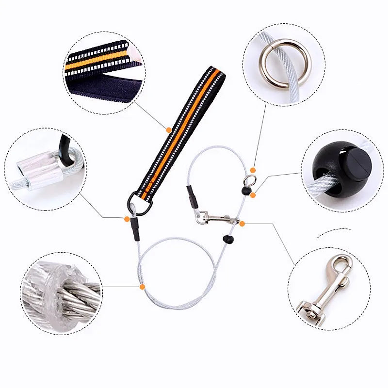 A white and black safety cable lanyard with orange accent stitching on the strap, shown with multiple circular detail callouts highlighting its metal ring, attachment clips, and cable construction on a white background.