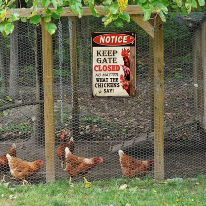 A rectangular metal sign with a red header reading 'NOTICE' and the phrase 'KEEP GATE CLOSED NO MATTER WHAT THE CHICKENS SAY!' hangs on a wooden chicken coop fence. Several brown chickens are visible behind the wire mesh in a backyard setting with trees and grass.