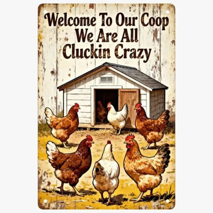 A rectangular metal tin sign with a rustic white-painted wood background, featuring the text 'Welcome To Our Coop We Are All Cluckin Crazy' above an illustration of several chickens around a small coop.