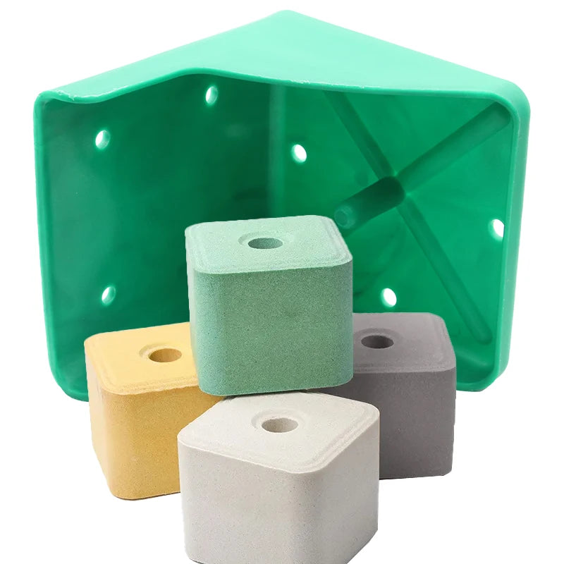 A green triangular plastic holder containing four small square foam blocks in mint green, yellow, gray, and off-white, shown on a white background.