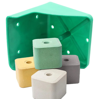 A green triangular plastic holder containing four small square foam blocks in mint green, yellow, gray, and off-white, shown on a white background.
