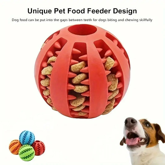 Red pet food feeder ball with dog food inside, shown with a dog and additional colorful balls on a white background.