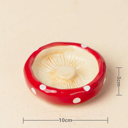 Red mushroom-shaped object with white polka dots on a beige background, featuring measurements.
