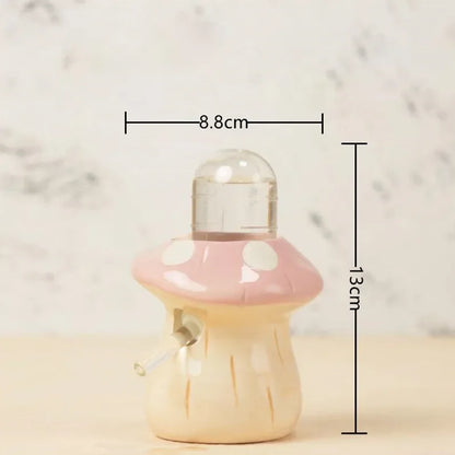 A small mushroom-shaped decorative object with a pink cap, white polka dots, and a cream body, shown on a light surface with overlaid dimension lines indicating 8.8 cm width and 13 cm height.